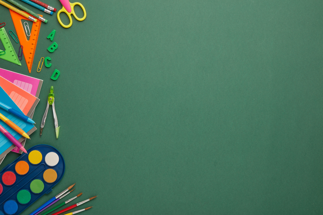 Chalkboard school supplies strewn across the bottom edge